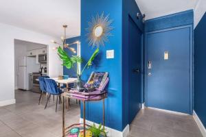 a blue room with a table and a blue wall at Groovy Old Town Scottsdale Condo in Scottsdale
