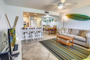 a living room with a couch and a table at Sunset Chateau 207 in St Pete Beach