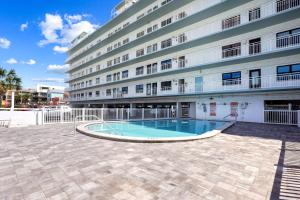 a swimming pool in front of a building at Sunset Chateau 207 in St. Pete Beach