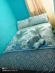 a bed with blue and white sheets and pillows at Excellent Pleasantville Apartment in San Fernando