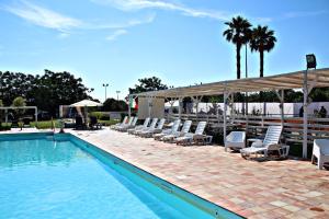 una piscina con sedie a sdraio e una piscina di Casa vacanze Barbera con piscina a Santa Lucia