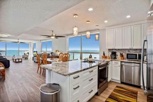 a kitchen and living room with a view of the ocean at Madeira Vista 601 in St. Pete Beach