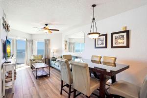 a dining room and living room with a table and chairs at Sunset Vistas 603W in St Pete Beach