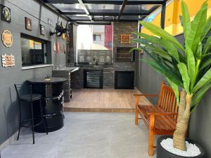 a bar with a table and a plant in a room at Apto centro, reformado, churrasqueira Privativa! in Balneário Camboriú
