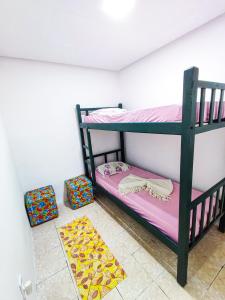 a room with two bunk beds and a rug at Casa da Debora in Lençóis