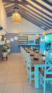 a dining room with a blue table and chairs at Hotel Villas Gaia Ecolodge in Uvita