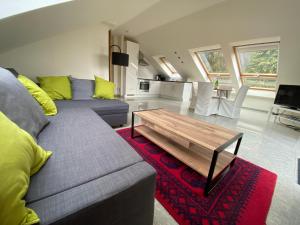 a living room with a couch and a coffee table at Ferienwohnung Fernblick Pfalz - mit Sauna in Weyher