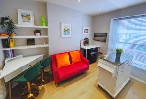 a room with a desk and a red chair at Bristol City Stays - Harbourside Apartments in Bristol