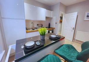a kitchen with a counter with pots and pans on it at Bristol City Stays - Harbourside Apartments in Bristol +8 photos