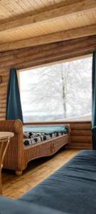 a bedroom with a window and a bed in a room at Cabana Himalaya Lodge cu ciubăr din inima munților Apuseni- masivul Buces -Vulcan 