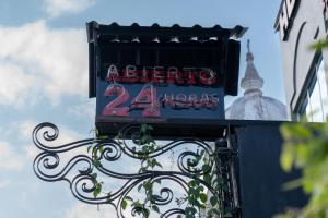 un panneau d'une heure au restaurant d'un bâtiment dans l'établissement Hotel El Meson, à La Dorada