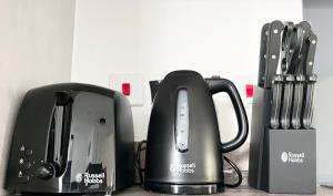 a toaster and a coffee maker on a counter at Riverside Apartment Chelmsford in Chelmsford