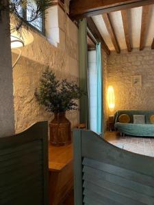 a living room with a couch and a chair at Le Relais, La Dormance, Le Bois Dormant in Châteauvieux