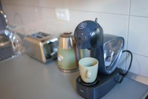 a coffee maker on a counter with a cup at City Break apartment in Split