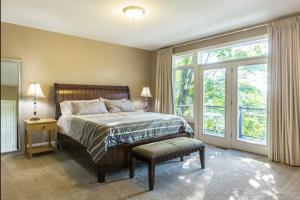 a bedroom with a bed and a large window at Cedar House Retreat in Excelsior