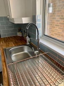 a kitchen sink with a faucet next to a window at Aylesbury Apartment for Contractors and Holidays in Aylesbury