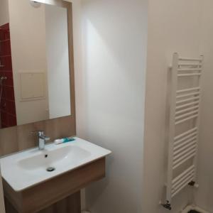 a bathroom with a white sink and a mirror at Gorgeous New apartment, 5mn walk to metro line 5 in Romainville