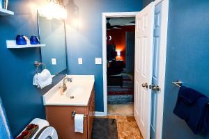 a blue bathroom with a sink and a mirror at Amazing Large 3 Bed house with King Bed less than 10 miles to DTWN in Atlanta