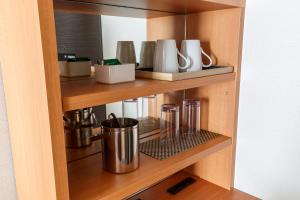 a cupboard with a bunch of utensils on it at Keisei Hotel Miramare in Chiba