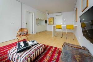 a living room filled with furniture and a tv at Lisbon Serviced Apartments - Liberdade in Lisbon