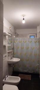 a bathroom with a sink and a toilet at Loft EL JAZMÍN in San Salvador de Jujuy