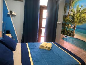 a bedroom with a bed with towels and a swimming pool at Toucan House in Coco