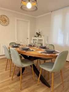 - une salle à manger avec une table et des chaises en bois dans l'établissement Ozollo Bekoa - Casa con piscina en el corazón de Urdaibai., à Gautegiz Arteaga