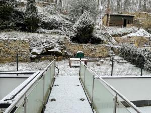 a walkway with snow on the ground and a fence at Penthouse with Garden and Parking in Center- KPG in Luxembourg