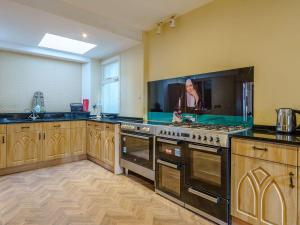 a large kitchen with a stove and a sink at The Old Nunnery - Uk7122 in Skelmorlie