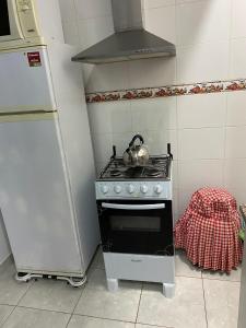 y cocina con fogones y hervidor de agua. en Edificio Aquarone 001, en Piriápolis