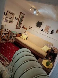 a living room with a bed and a couch at House Seoska OAZA in Crnoklište