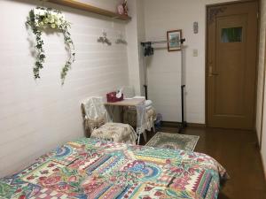 a bedroom with a bed and a table and a door at Otsu - House / Vacation STAY 2968 in Otsu
