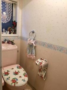 a bathroom with a toilet with a flowery toilet paper dispenser at Otsu - House / Vacation STAY 2968 in Otsu