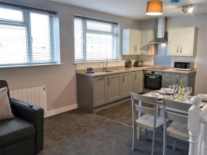 a kitchen with a table and a dining room at Apartment 3 The Beach Hut - Uk31822 in Great Yarmouth