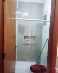 a bathroom with a shower with a glass door at casa da paz in Porto Seguro