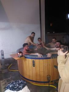 a group of men in a hot tub at Pensiunea Iris in Turcineşti