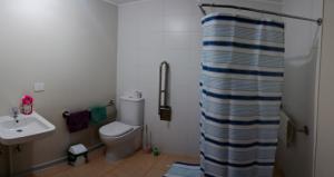 a bathroom with a toilet and a sink at Departamento familiar en Osorno in Osorno