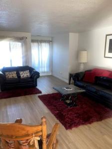 a living room with a couch and a table at 4 Bedroom Home-Casino-State Farm Stadium only 2 Miles in Glendale