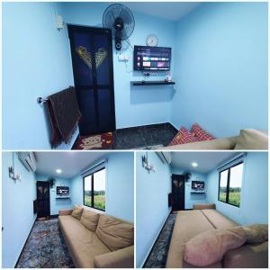 een woonkamer met blauwe muren en een bank bij Cabin stay with Sunrise and plane spotting view in Shah Alam