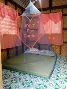 a table with an umbrella on top of a table at Jolits Ecogarden Integrated Farm in Batuan