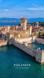 a view of a castle in the water at PAGANINI suits and apartments in Sirmione