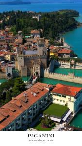 an aerial view of a city with water and buildings at PAGANINI suits and apartments in Sirmione