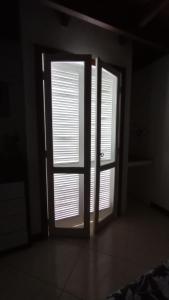 eine offene Tür in einem Zimmer mit zwei Fenstern in der Unterkunft Duplex Top! - Visit and Love Us - Piccola Marina Bracuhy in Angra dos Reis