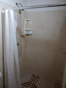 a shower with a shower curtain in a bathroom at Hotel Bethesda in Aguachica
