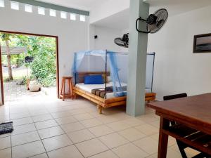 a room with a bed with a mirror and a table at Merdeka House in Maluk