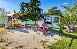 a playground with a swing set and a house at Gorgeous Home In Vodnjan With Wifi in Vodnjan