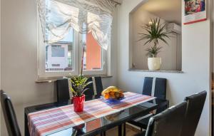 a dining room with a table and a window at Gorgeous Home In Vodnjan With Wifi in Vodnjan