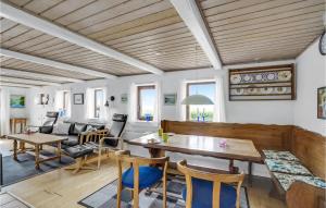 a living room with a table and chairs at Gorgeous Home In Thyholm With Kitchen in Thyholm