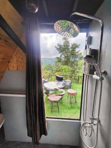 a view of a room with a table and a window at Flower hill 180 in Chiang Rai