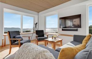 a living room with a couch and chairs and a tv at Lovely Home In Fredericia With House Sea View in Fredericia